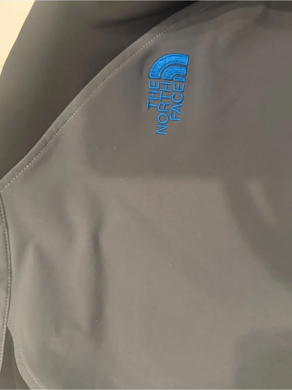 The North Face Men’s Gray Softshell Jacket with Black Sleeves and Blue Trim